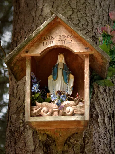 Virgin Mary Statue in Rustic Wooden Wayside Shrine for Tourists image