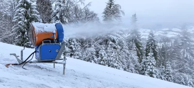 Active Snow Cannon Creating Fresh Snow on Winter Ski Slope image