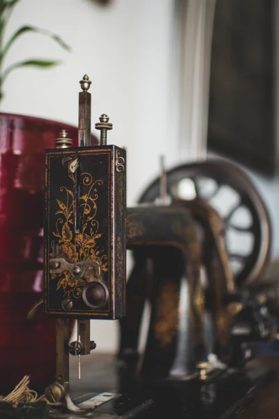 Old sewing machine is made of metal and has a black color