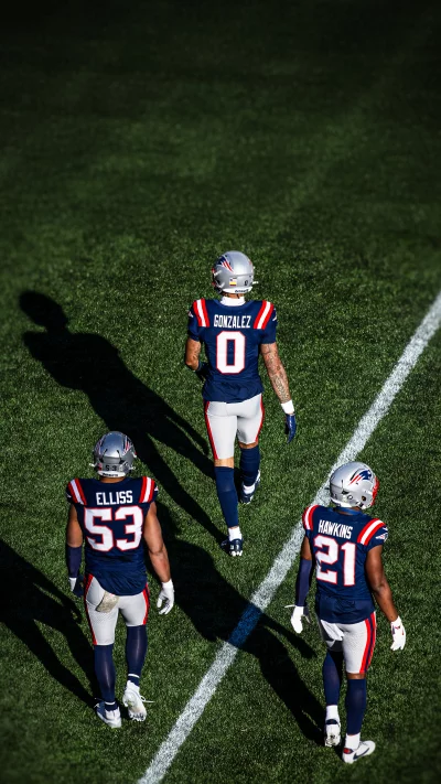 New England Patriots Football Players Walking on Green Field image