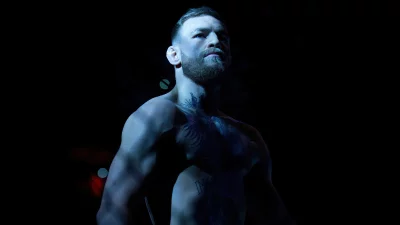 Conor McGregor: Intense Portrait, Dynamic MMA Fighter in Dramatic Blue Lighting image