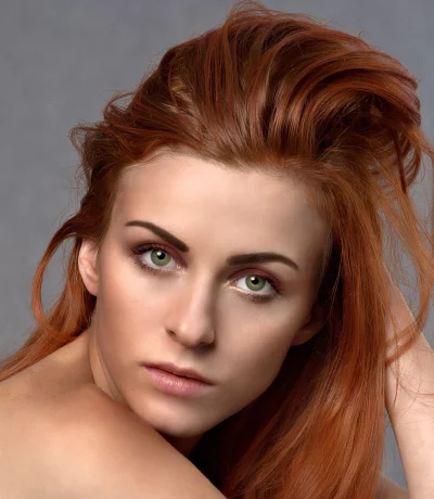 Intense Portrait of a Red-Haired Woman with Striking Green Eyes image