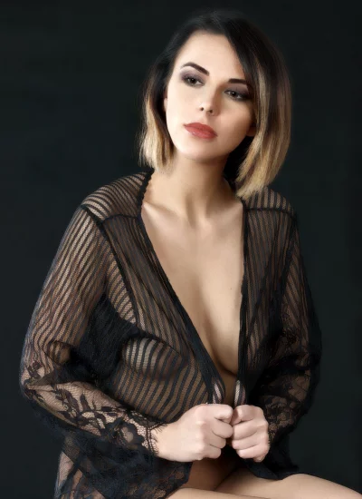 Alluring Woman in Sheer Black Lace Robe with Striking Hairstyle Studio Portrait image
