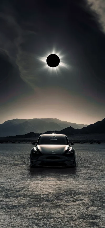 Black Tesla electric car under a spectacular solar eclipse in a vast desert landscape image