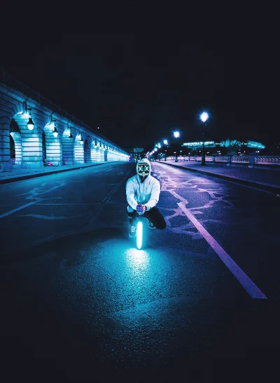 Crouching Figure with Glowing Purge Mask and Neon Light on Urban Street image