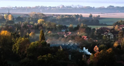 Foggy Autumn Morning over European Village with Colorful Trees and Red Roofs image
