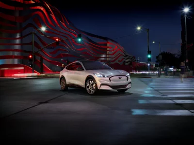 White Ford Mustang Mach-E Electric SUV Navigating Dynamic Urban Night Scene image