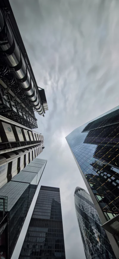 Modern London Cityscape with Iconic Skyscrapers Under Cloudy Sky