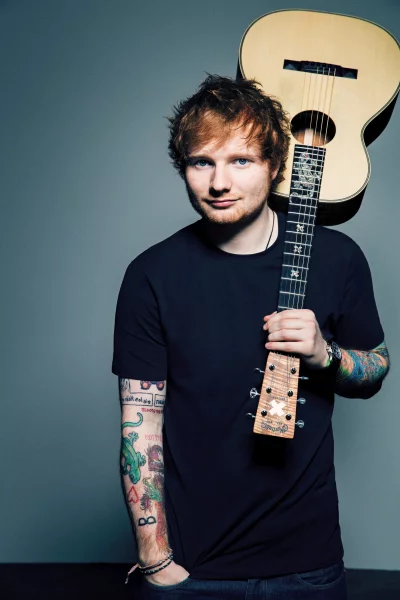 Ed Sheeran Posing with Acoustic Guitar in a Modern Studio Portrait image