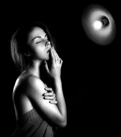 Monochrome Portrait of Woman with Closed Eyes Bathed in Dramatic Spotlight image