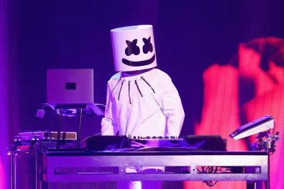 Electronic Music DJ Marshmello Live Performance Under Dynamic Purple and Red Lights image