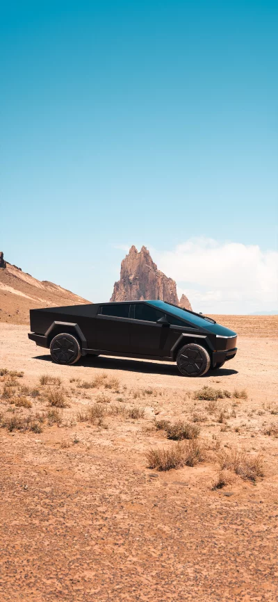 Sleek Black Tesla Cybertruck in Arid Desert Landscape Under Clear Sky image
