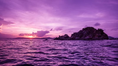 Vibrant Purple Sunset Over Rocky Tropical Island in Pacific Ocean image