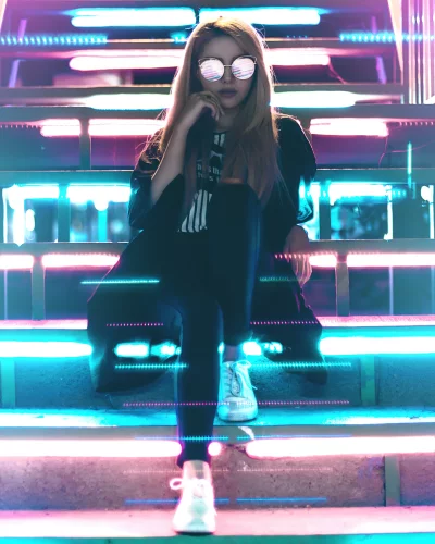 Stylish Woman in Cyberpunk Neon Glare with Reflective Sunglasses image