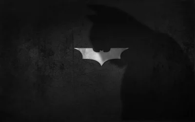 Iconic Batman Logo on Grungy Black Background with Dark Knight Shadow image