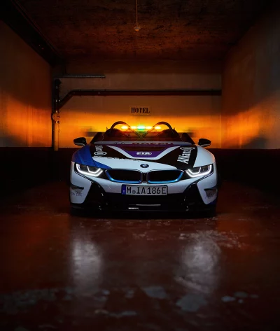 BMW i8 Safety Car Illuminated in Atmospheric Garage with Amber Lighting image