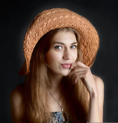 Charming Blonde Woman in Straw Hat with Finger on Lips image