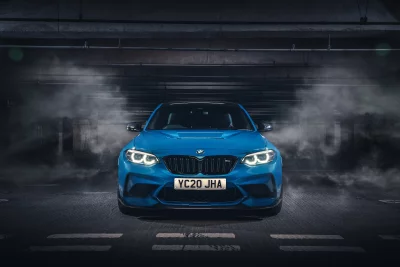 Dynamic Blue BMW M2 Sports Car Front View Cinematic Underground Parking Wallpaper image