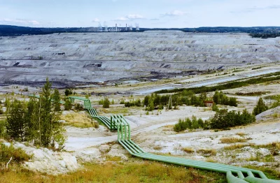 Massive Open-Pit Mine and Industrial Power Plant Landscape with Green Pipelines image