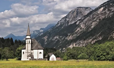 Historic Alpine Church in Lush Mountain Meadow Landscape image