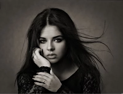Dramatic Black and White Portrait of Pensive Young Woman with Windswept Hair image