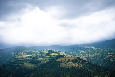 Overcast Mountain Landscape with Rolling Hills and Village