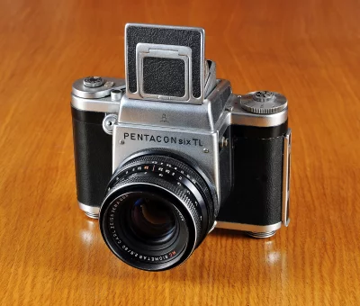 Classic Pentacon Six TL Medium Format Camera on Polished Wooden Surface image