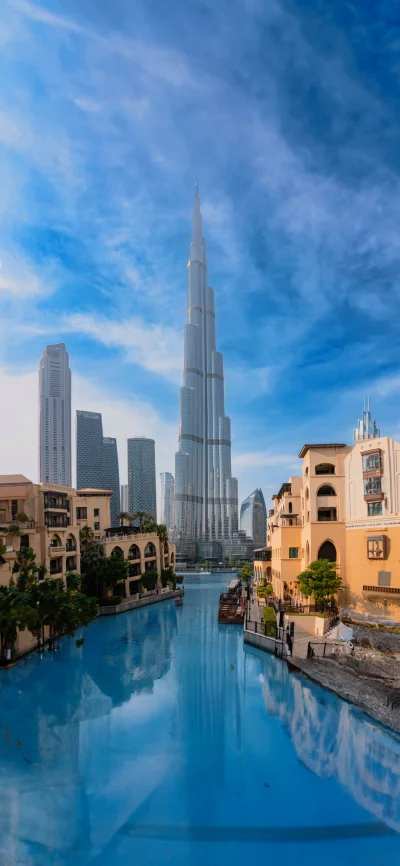 Iconic Dubai Skyline with Burj Khalifa and Canal on a Sunny Day