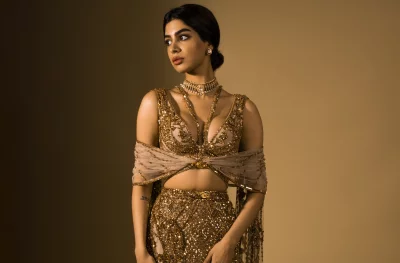 Beautiful South Asian Woman Adorned in Shimmering Golden Lehenga and Elegant Jewelry image