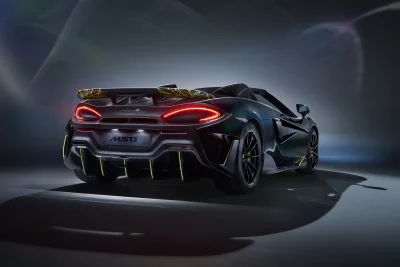 Sleek Dark McLaren Sports Car Rear View with Vibrant Green Accents image