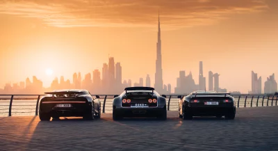 Three Luxurious Bugatti Supercars Parked at Golden Sunset with Dubai Skyline image