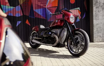 Sleek Red Custom Cruiser Motorcycle Parked Against Vibrant Geometric Graffiti Wall Art image