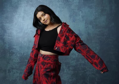 Confident Young Woman in Vibrant Red and Black Abstract Patterned Denim Outfit image