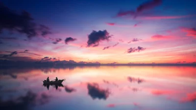 Serene Sunset Kayak Adventure on Reflective Lake Water image