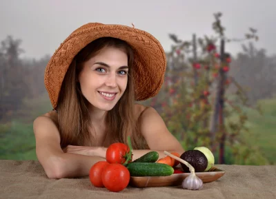 Smiling Young Woman in Straw Hat with Fresh Garden Harvest image