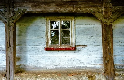 Weathered Wooden Wall with a Distressed Window Frame on a Rustic Building Facade image