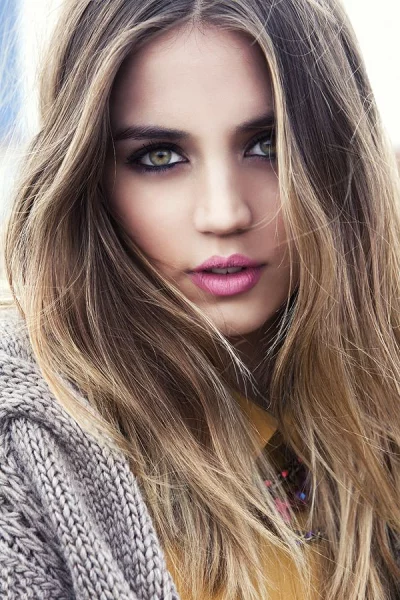 Stunning Young Woman with Flowing Blonde Hair and Vibrant Pink Lips Looking at Camera image