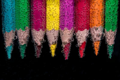 Vibrant Color Pencils Submerged in Water with Sparkling Bubbles image