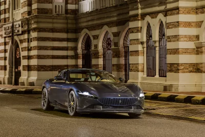 Ferrari Roma Luxury Sports Car Parked at Night by Historic Building image