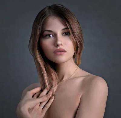 Captivating Young Woman with Long Brown Hair Posing Elegantly in Studio Portrait image