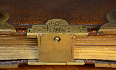 Ornate Antique Leather Book with Decorative Brass Clasp and Aged Pages image