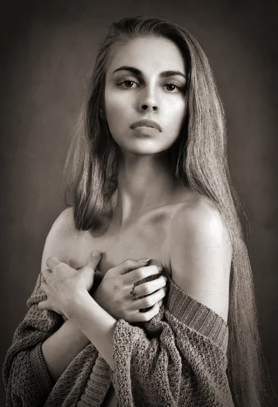Elegant Sepia Tone Portrait of a Young Woman with Contemplative Gaze image