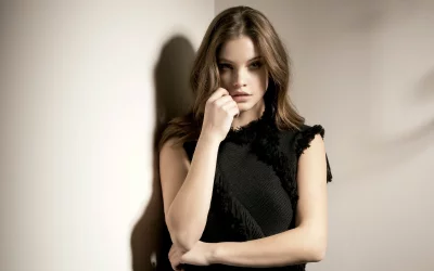 Charming Young Woman with Pensive Expression in Black Textured Fashion image