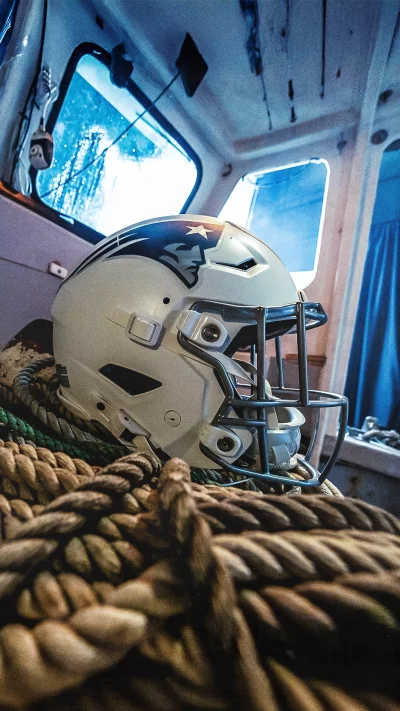 New England Patriots Football Helmet Resting on Nautical Ropes in a Boat Cabin