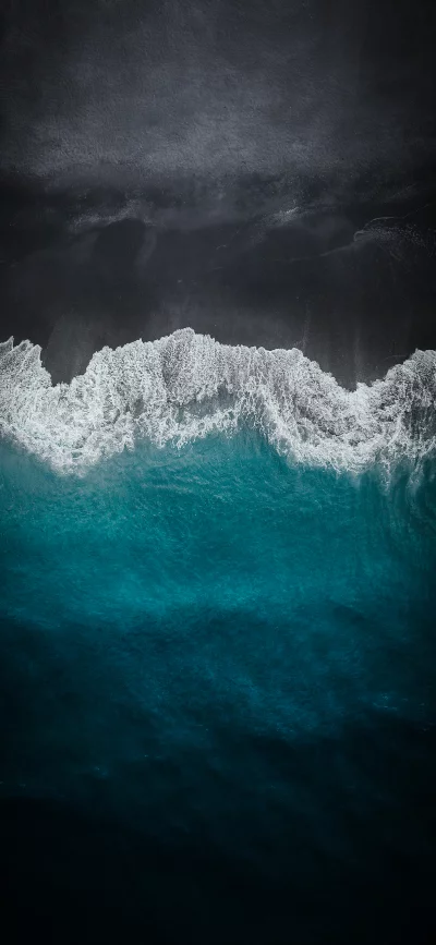 Aerial Drone View of Majestic Ocean Waves Crashing on Black Sand Beach