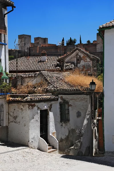 Historic Cobblestone Street in Granada's Albaicín District with Alhambra Fortress View image