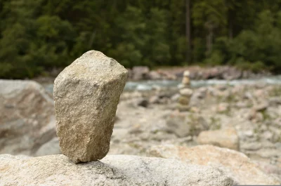 Balanced Stone Cairn by Mountain River Landscape image