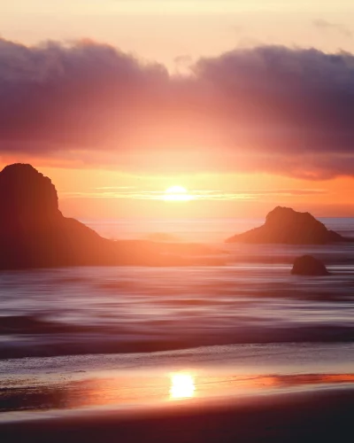 Dramatic Sunset Over Rocky Coastline with Long Exposure Ocean Waves image