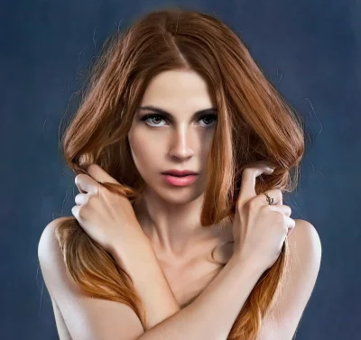 Redhead Woman Posing with Crossed Arms and Flowing Hair image