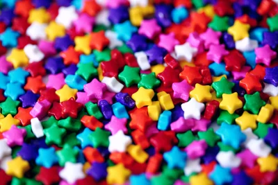 Vibrant Colorful Star Shaped Candies Sprinkles Background for Celebrations and Sweet Designs image